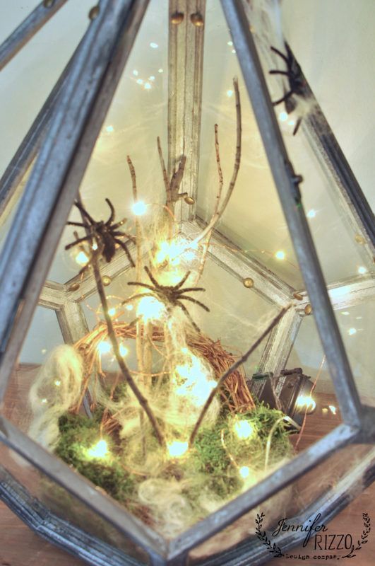 a Halloween terrarium with moss, spiders, lights is a very cool and bright decor idea that you can realize