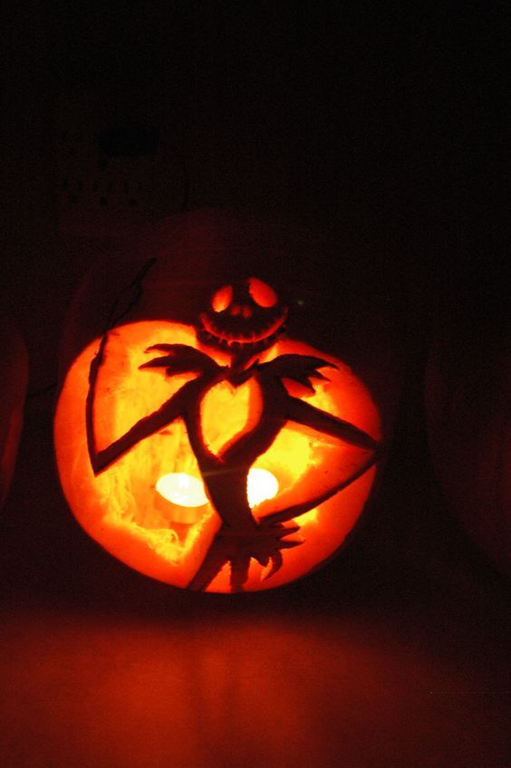a Jack Skellington inspired pumpkin with candles inside is a pretty carved piece for Halloween decor