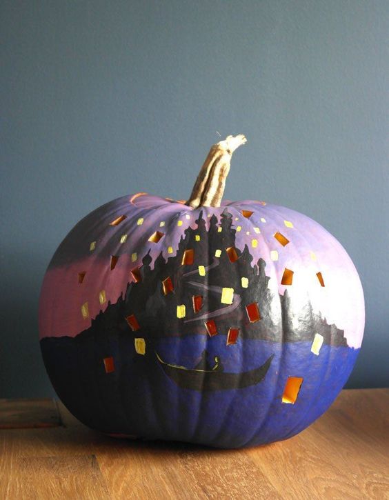a beautiful painted and cutout pumpkin with a lovely scene is a cool Halloween decoration to make