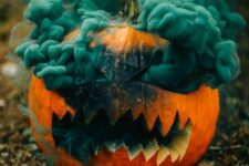 a carved Halloween pumpkin with a green smoke bomb inside will make your Halloween photos ultimate
