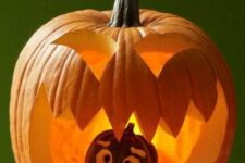 a carved pumpkin with a scary face and a smaller black one inside, frightened, are a cool combo for Halloween decor
