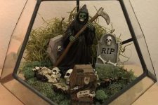a cemeterrium or a Halloween terrarium with moss, skulls, tombstones, a death and greenery is fun and cool
