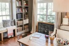 a cottage home office with a wooden desk, a chalkboard sign, a built-in storage unit and a bench is very welcoming and cool