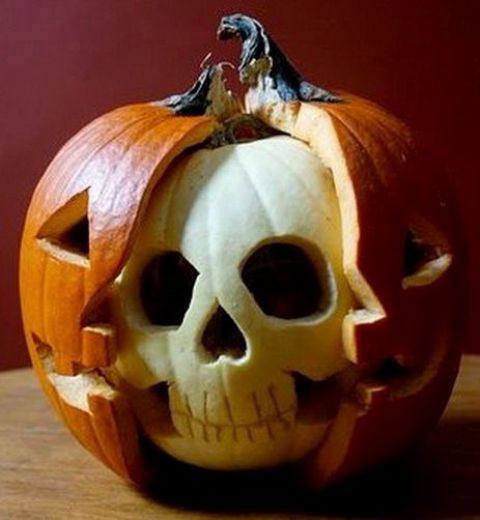 a creative Halloween pumpkin carved, with a pumpkin skeleton face inside is a lovely Halloween decoration to try