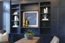 a farmhouse home office with navy walls – one of them taken by a storage unit, neutral furniture and gold touches for more elegance