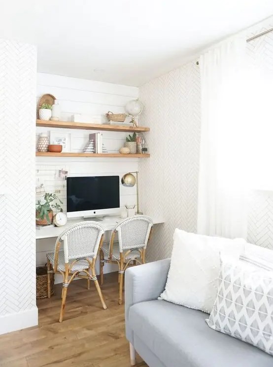 a farmhouse niche with shiplap, built in stained shelves, a white desk, rattan chairs, decor, potted greenery and a table lamp