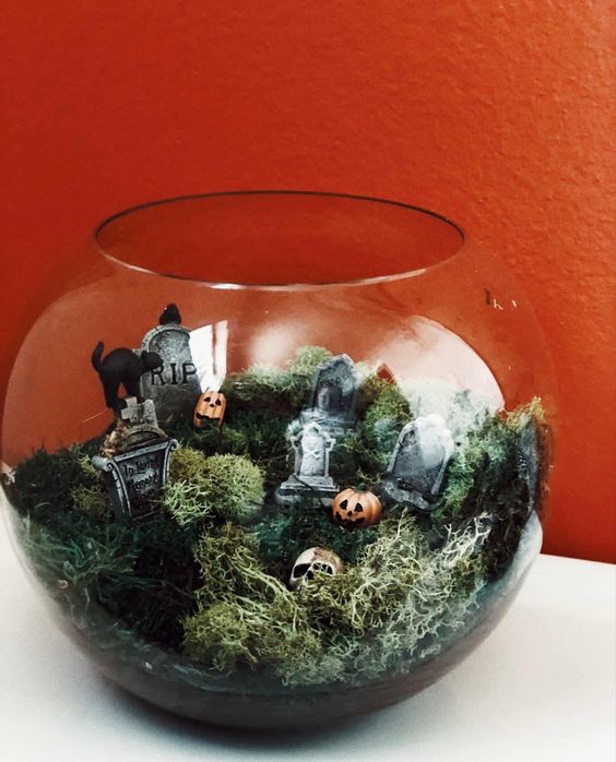 a fish tank with moss, tombstones, jack-o-lanterns and a black cat is a lovely idea for Halloween decor and it's easy to make