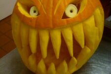 a frightful Halloween pumpkin with large teeth and horns plus big eyes is a wow idea