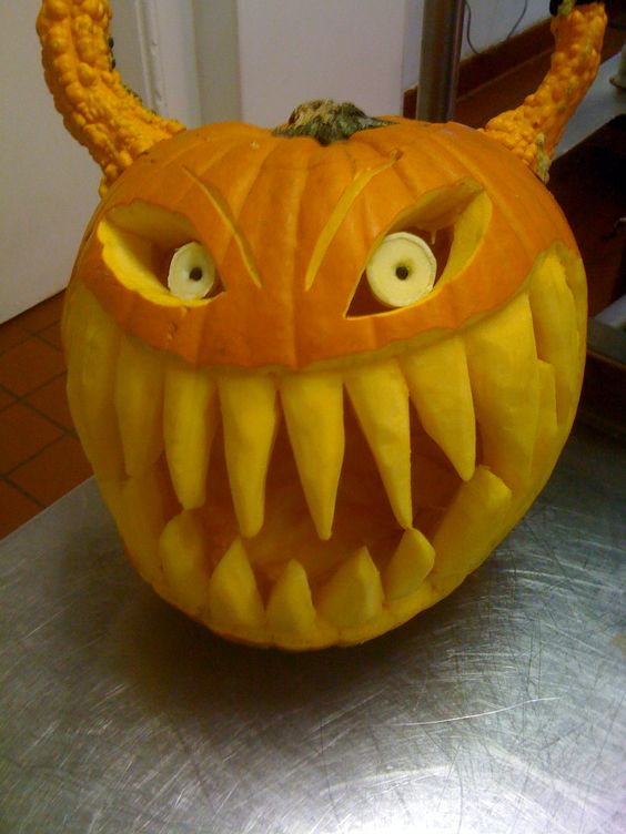 a frightful Halloween pumpkin with large teeth and horns plus big eyes is a wow idea