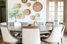 a gorgeous modern farmhouse dining room done in neutrals and with a large wooden round table