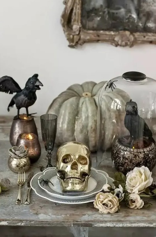 a heirloom pumpkin, a crow in a cloche, blackbirds, candles in chic candleholders for Halloween