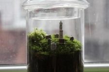 a jar with moss and a small graveyard is a lovely Halloween decor idea, it can be repeated easily
