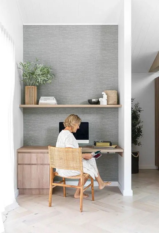 a large niche with a built in shelf and a desk with storage drawers, greenery and decor is a cool idea for a modern space