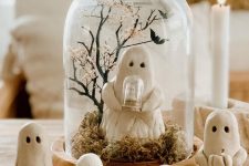 a lovely cloche with moss, a ghost holding a cloche and a tree with bats is a cool idea for Halloween