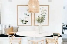a lovely modern farmhouse dining room with a built-in bench, an oval table and wooden chairs, a woven pendant lamp