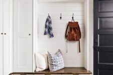a lovely modern farmhouse mudroom with cabinetry, open storage compartments, drawers is a lovely and cozy space
