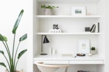 a minimalist white niche with built-in shelves and a sleek desk with drawers, some potted plants, books and baskets