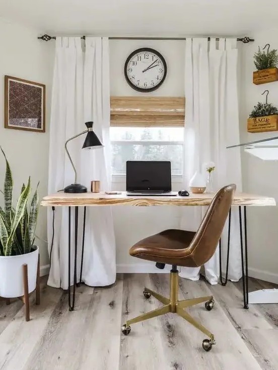 a modern country home office in creamy shades, with a hairpin desk, a leather chair, creamy curtains and potted plants on the floor and wall