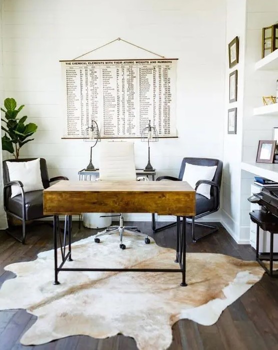 a modern farmhouse home office with a stained desk, black chairs, a built-in storage unit and a cowhide rug