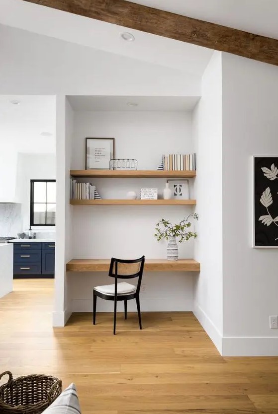 a niche with built-in shelves and a desk, some books and decor and a comfortable chair is a lovely idea for a modern home