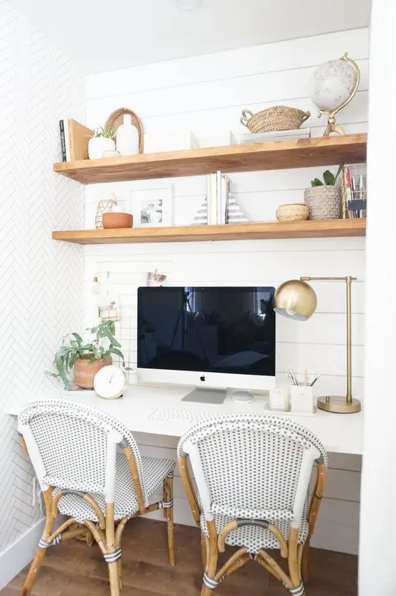 a niche with shiplap, built-in stained shelves and a desk, some rattan chairs, some decor and greenery is a cozy farmhouse space