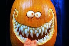 a scary Halloween pumpkin with several rows of teeth, a tongue and googly eyes is a cool decoration