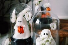 a series of cloches with lovely ghosts holding various stuff, pumpkins, flowers and so on is a cool idea for Halloween