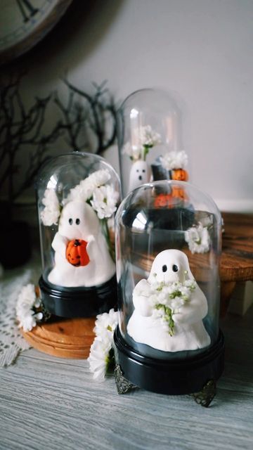 a series of cloches with lovely ghosts holding various stuff, pumpkins, flowers and so on is a cool idea for Halloween