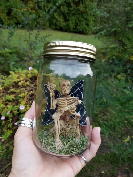 a small and cool Halloween terrarium of a skeleton with wings and grass can be easily repeated