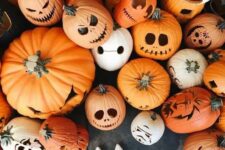 a whole assortment of cool Halloween jack-o-lanterns is a lovely idea to style your porch and looks amazing