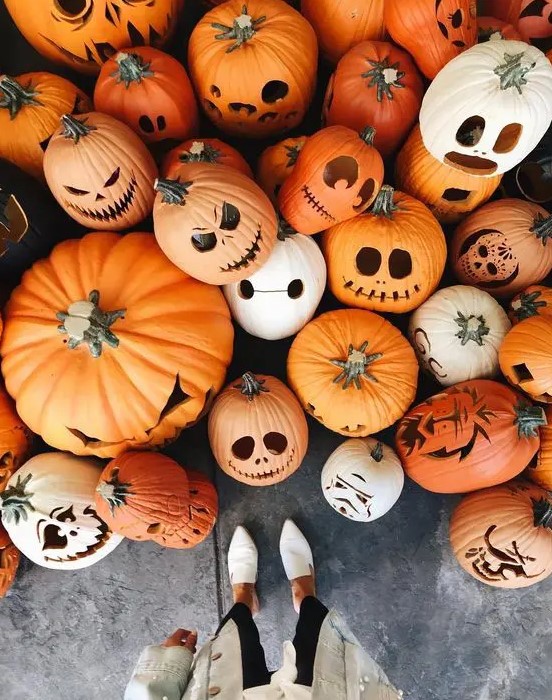 A whole assortment of cool Halloween jack o lanterns is a lovely idea to style your porch and looks amazing
