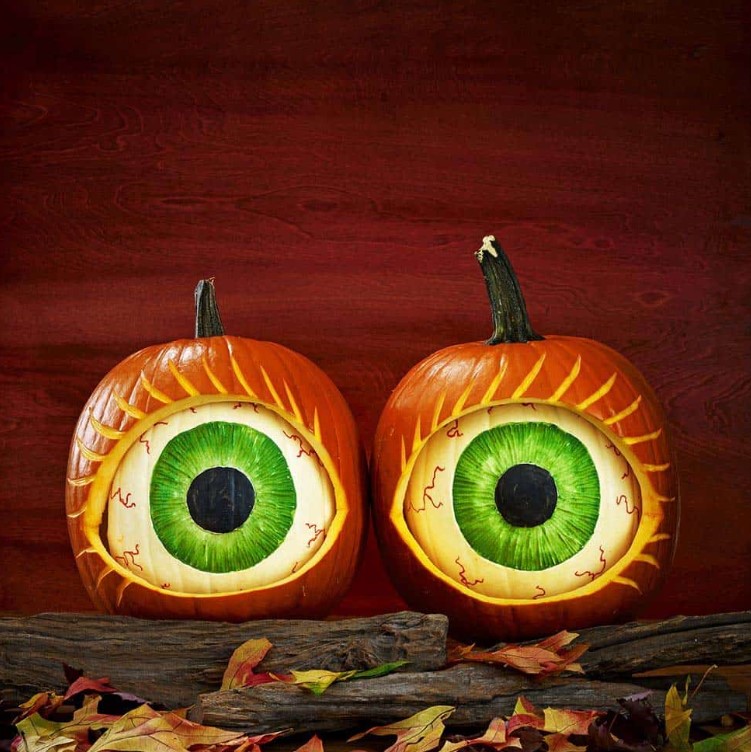 Jaw dropping scary eye pumpkins composed of orange and white ones with decor inside will strike everyone