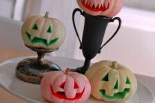 very simple and fast to make carved mini pumpkins accented with paint are great for any Halloween decor