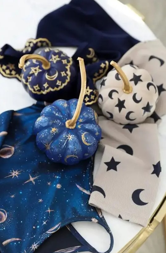 very pretty small pumpkins in blue, navy and white, with stars, moons and tiny sparkles are great for celestial Halloween parties