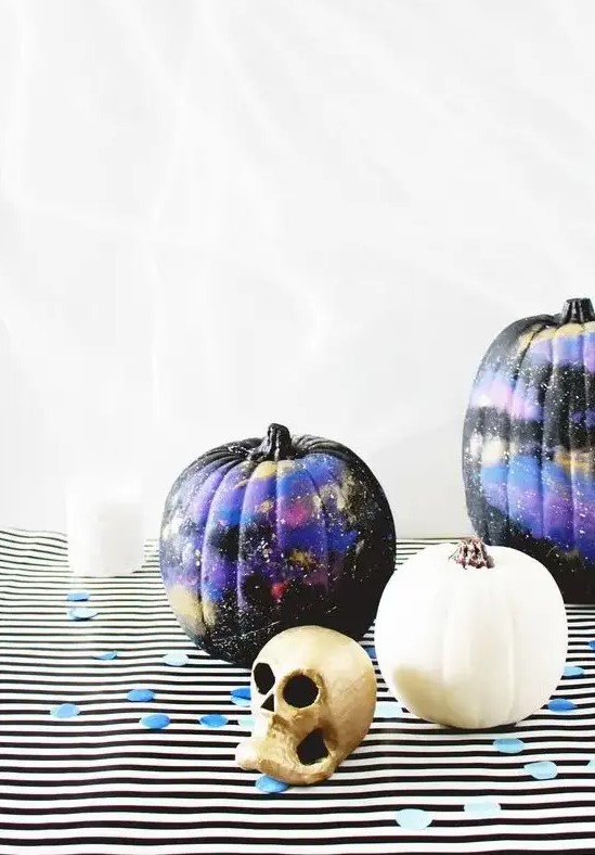 black, purple and gold galaxy-themed pumpkins are amazing for Halloween, bold, catchy and mysterious