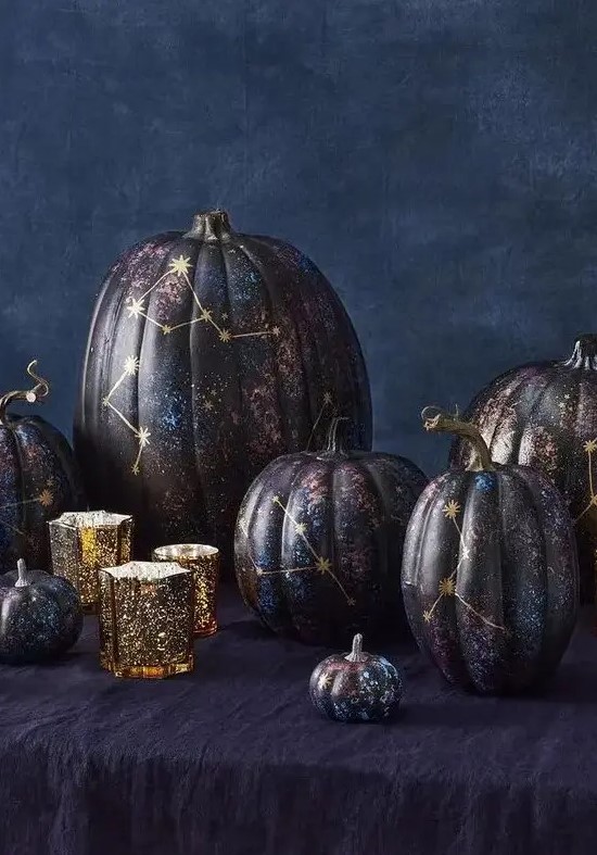 an arrangement of jaw dropping black, purple and blue constellation pumpkins with gold constellations is fantastic