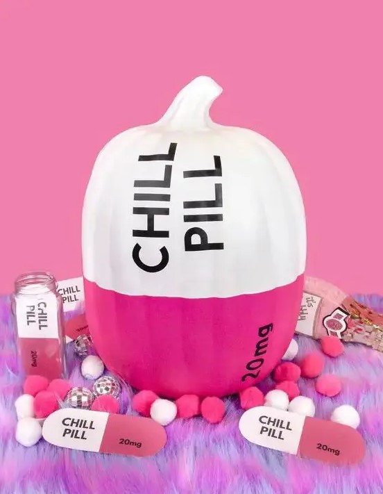 a modern color block pumpkin in hot pink and white, with black letters and numbers is a great idea for a modern Halloween party