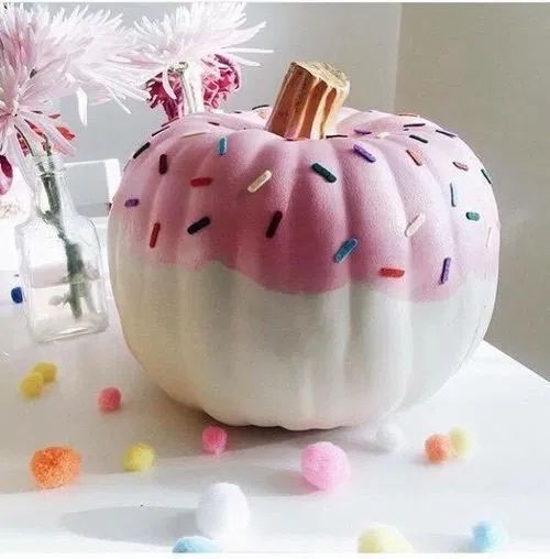 a beautiful pink and white donut-inspired pumpkin with confetti is a lovely idea for fall or Halloween decor