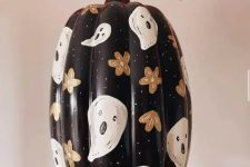 28 a beautiful painted black Halloween pumpkin with flowers and ghosts is a cool and chic solution