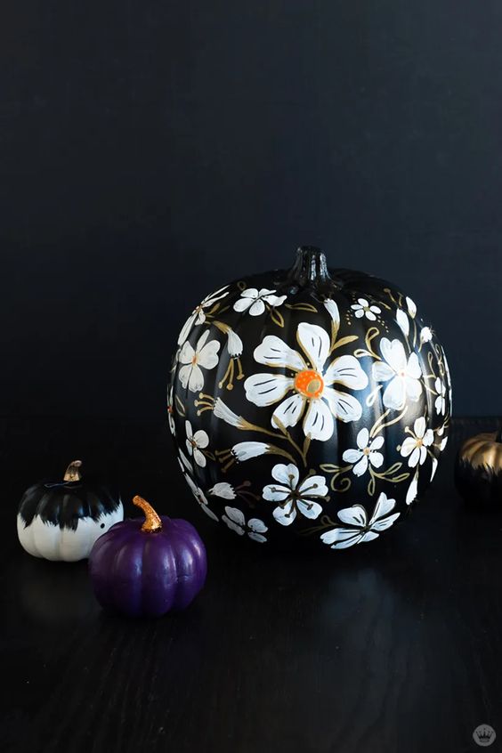 a refined black floral pumpkin isn't a very easy craft but it looks very chic and will be great for Halloween