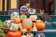 40 an arrangement of painted pumpkins with bold boho flowers, cats, owls, ghosts and letters is a fun idea for fall or Halloween decor