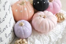 45 pastel and a black pumpkin with stars are great for fall and Halloween decor in soft shades