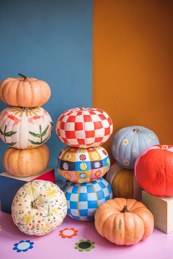 colorful painted pumpkins with patterns and flowers are great for gall and Halloween decor