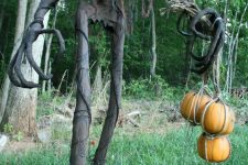 a Grim Halloween decoration with pumpkins is a super cool and bold idea for outdoors, for your yard
