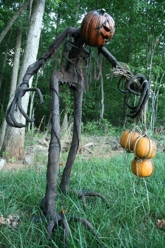 a Grim Halloween decoration with pumpkins is a super cool and bold idea for outdoors, for your yard