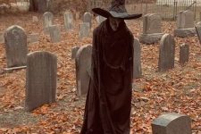 a Halloween scene in the yard imitating a graveyard and a witch with a hat is a cool solution