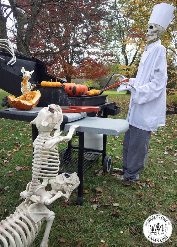a Halloween skeleton scene with a skeleton cook cooking the pumpkins on the grill and skeleton dogs