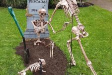 a Halloween yard decoration with skeletons and a skeleton dog, a tombstone is a cool solution for outdoors