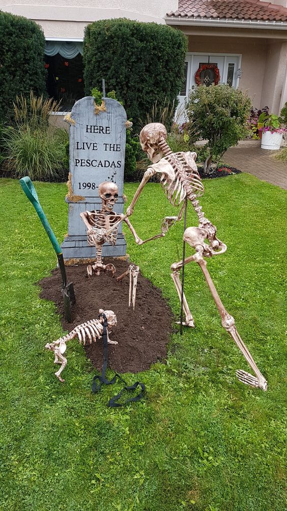 a Halloween yard decoration with skeletons and a skeleton dog, a tombstone is a cool solution for outdoors