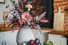 a beautiful and refined fall faux flower arrangement in pink, lilac and blush, with eucalyptus and bold leaves